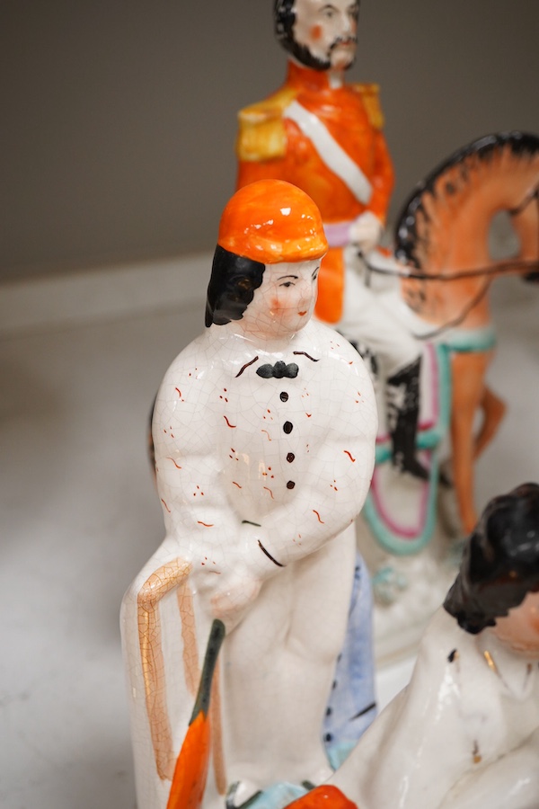 A collection of seven Staffordshire figures, including Queen Victoria - 45cm high, a cricketer, a boy reading, Tom King etc